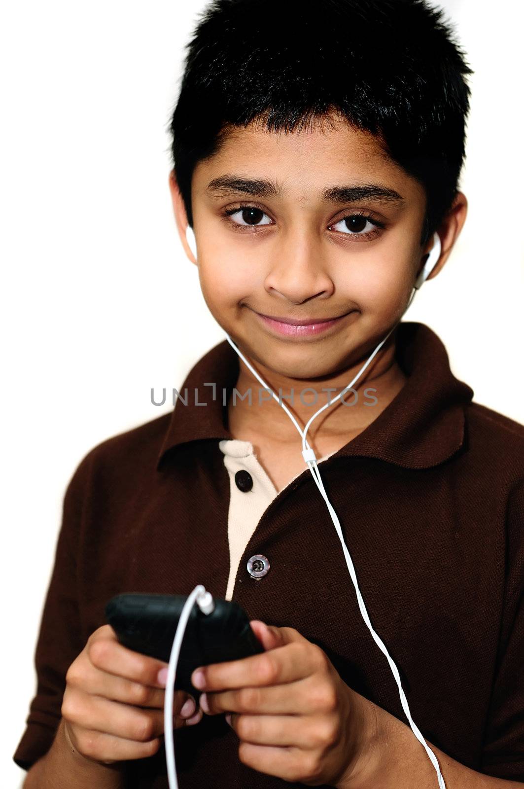 An handsome Indian kid listening to music happily
