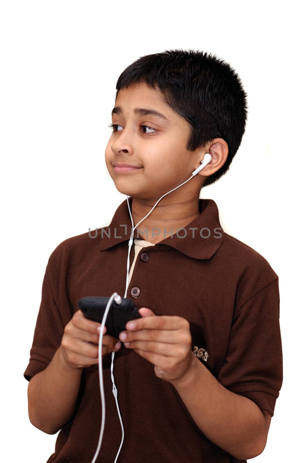 An handsome Indian kid hearing music with headphones
