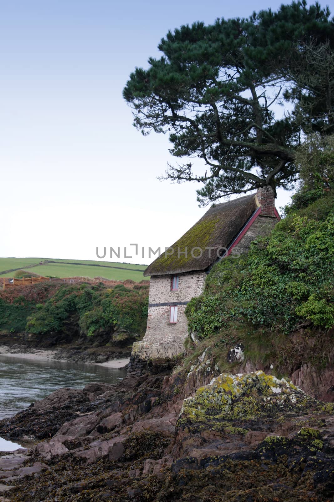 A rural thatched country cottage located next to the river seven esturay at Bantham in Devon.