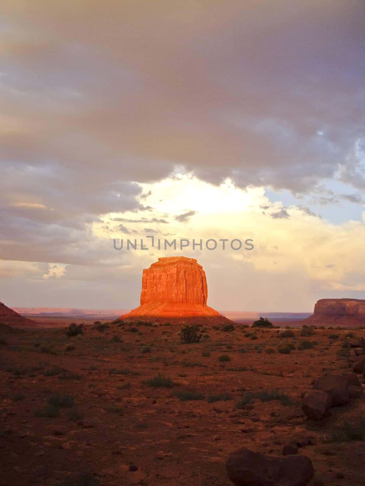 Sunset beams on rock in Monument Valley after a Summer storm