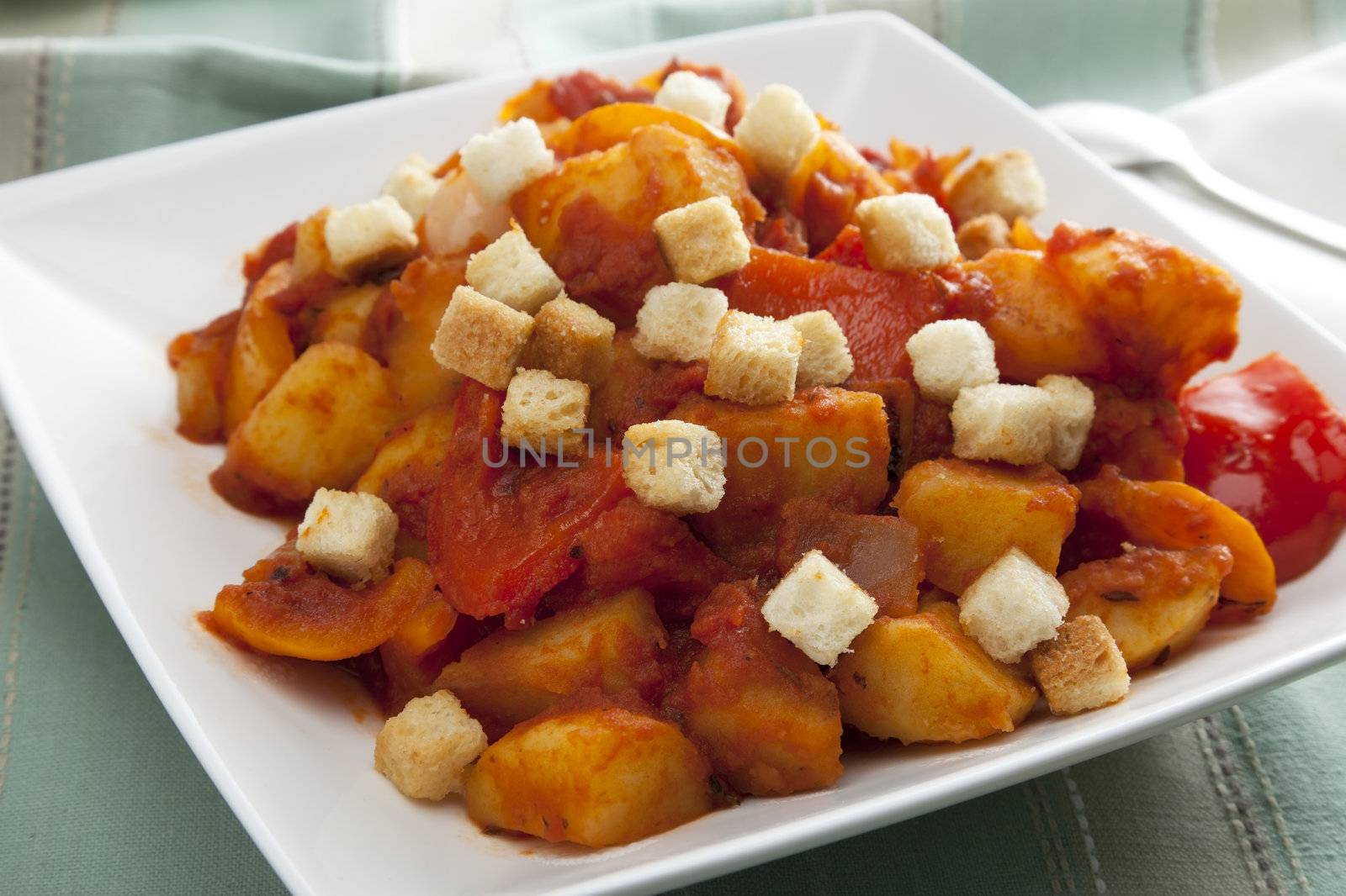 Vegetarian hungarian goulash in white bowl with croutons.