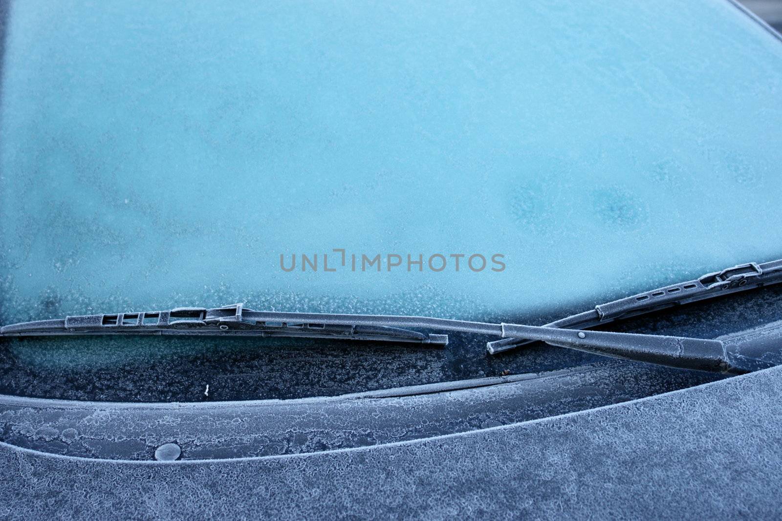 car windshield covered with ice and snow