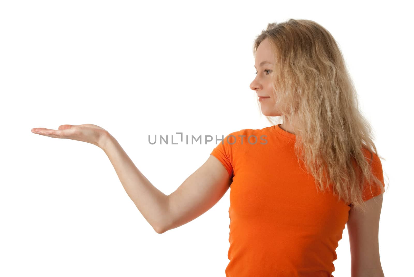 Nice young woman in orange t-shirt holding her hand palm up, ready to hold your product.