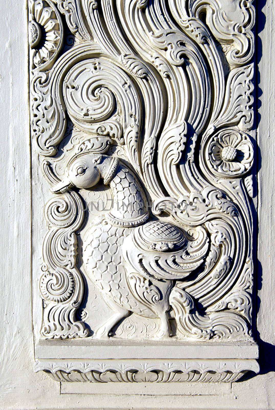 Image of a duck, carved, etched or sculpted in plaster