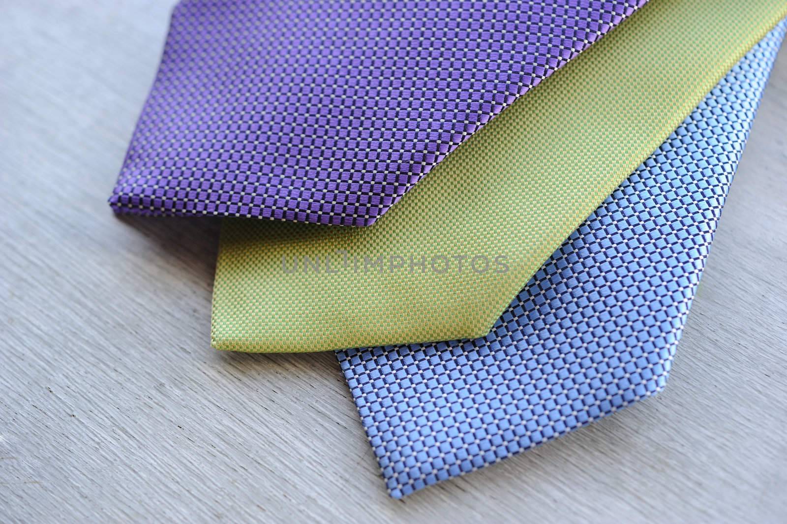 Image of 3 ties on white wood background