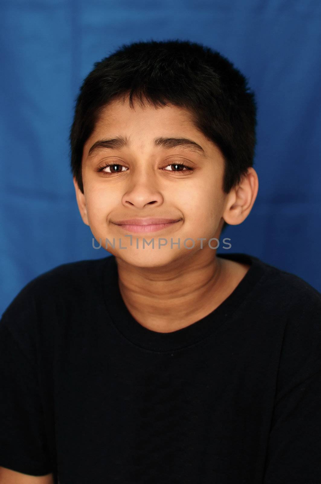 An handsome Indian kid showing happiness by miling