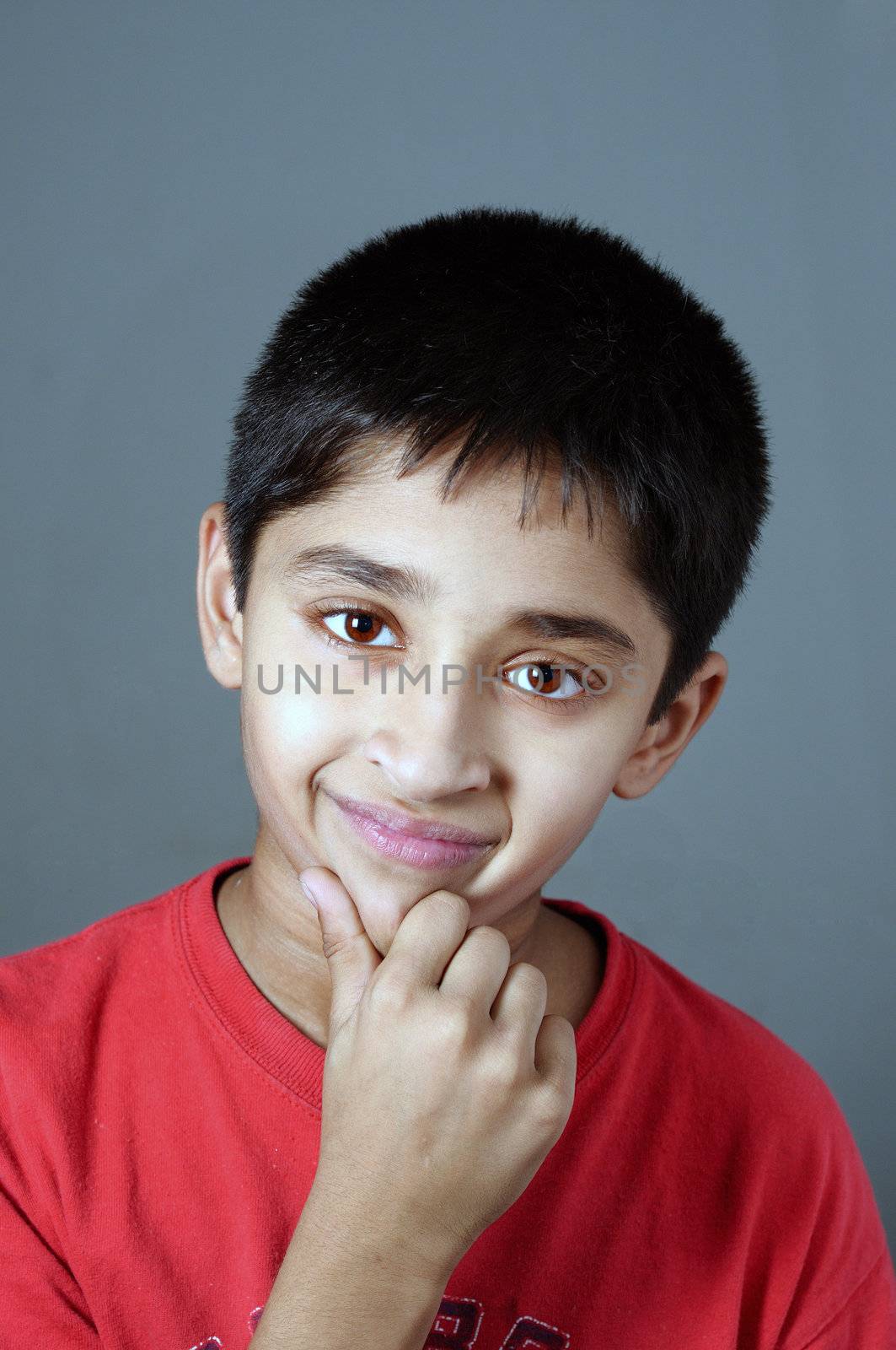 An handsome Indian kid smiling nicely for you