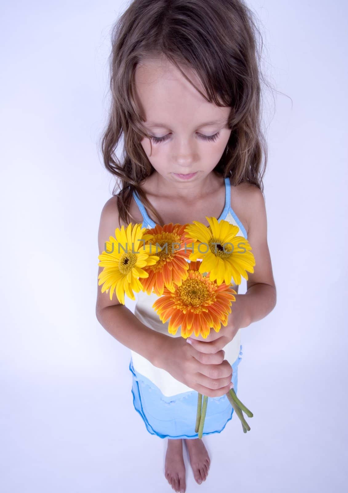 A little girl holding in her hand a beautiful flower