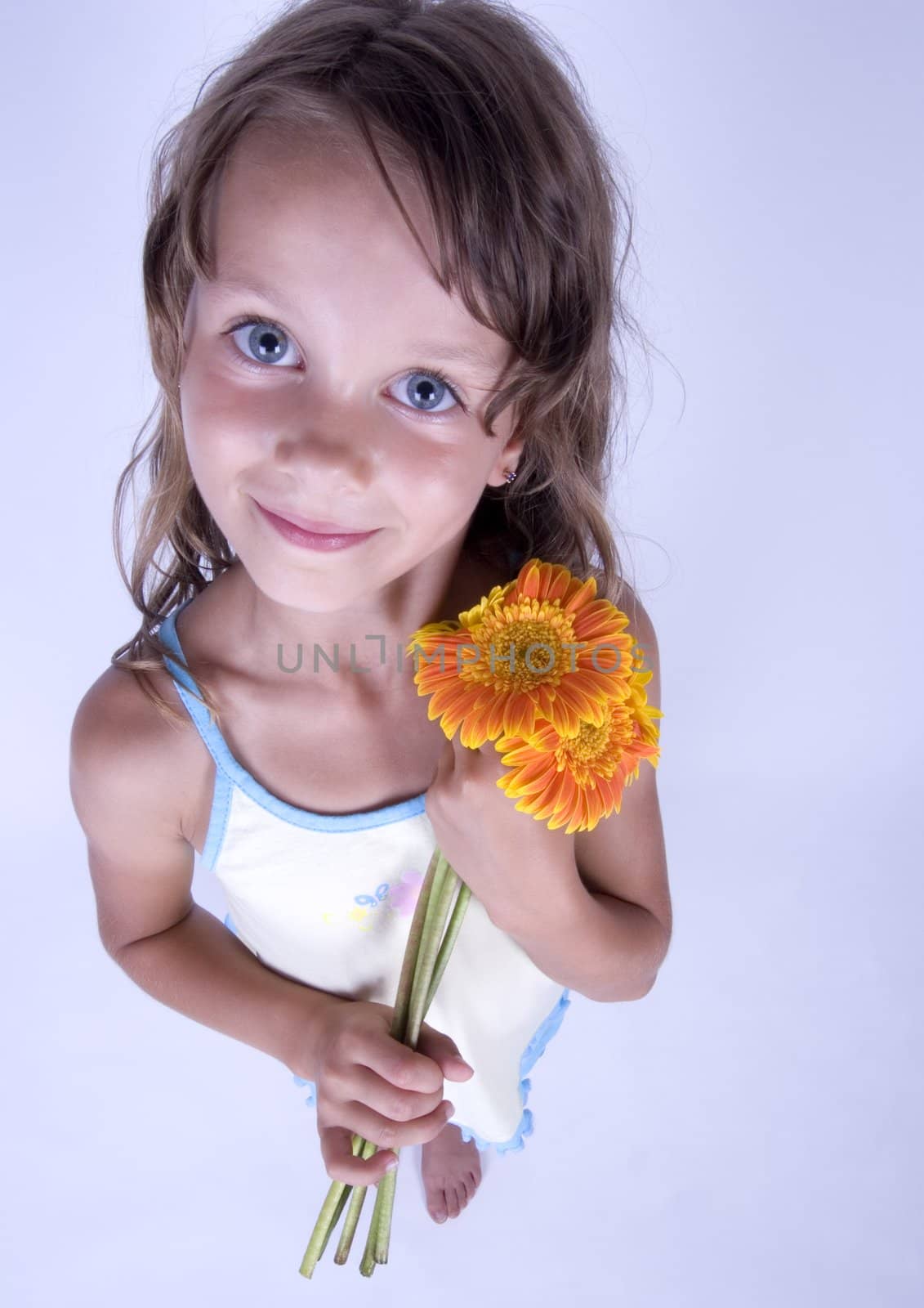 A little girl holding in her hand a beautiful flower