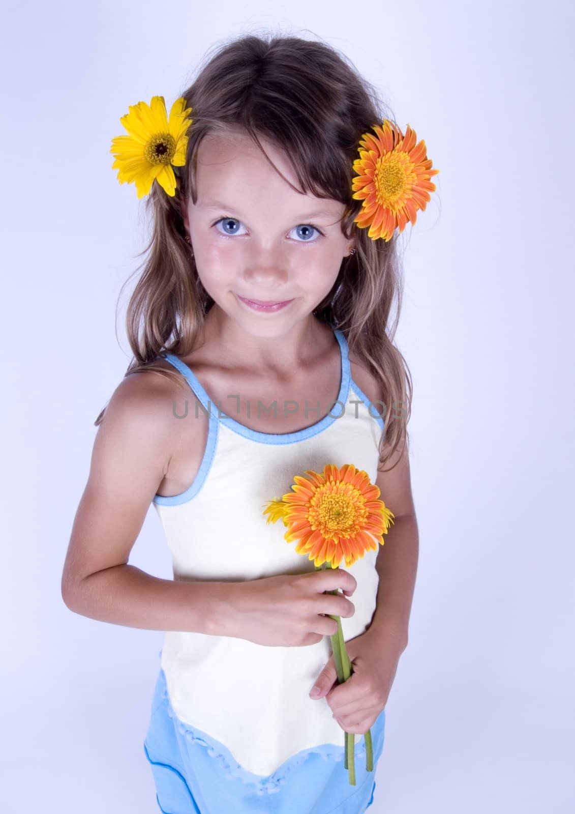 A little girl holding in her hand a beautiful flower