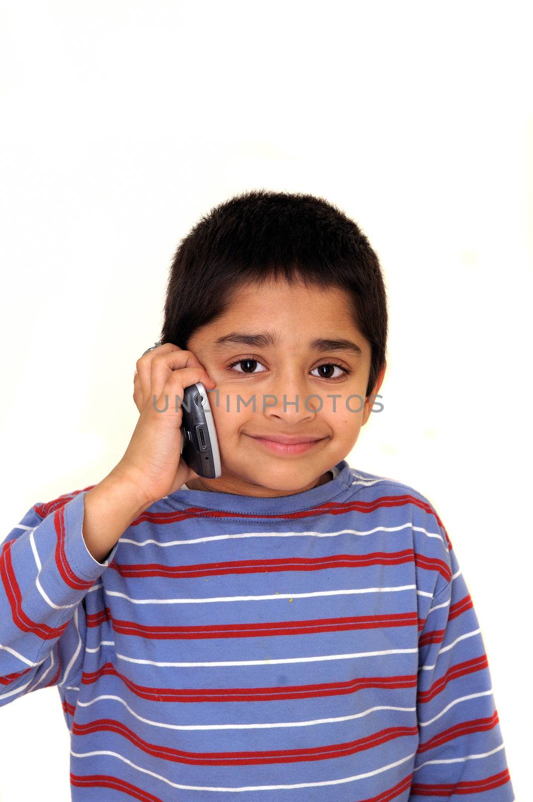 An handsome Indian kid talking on the phone