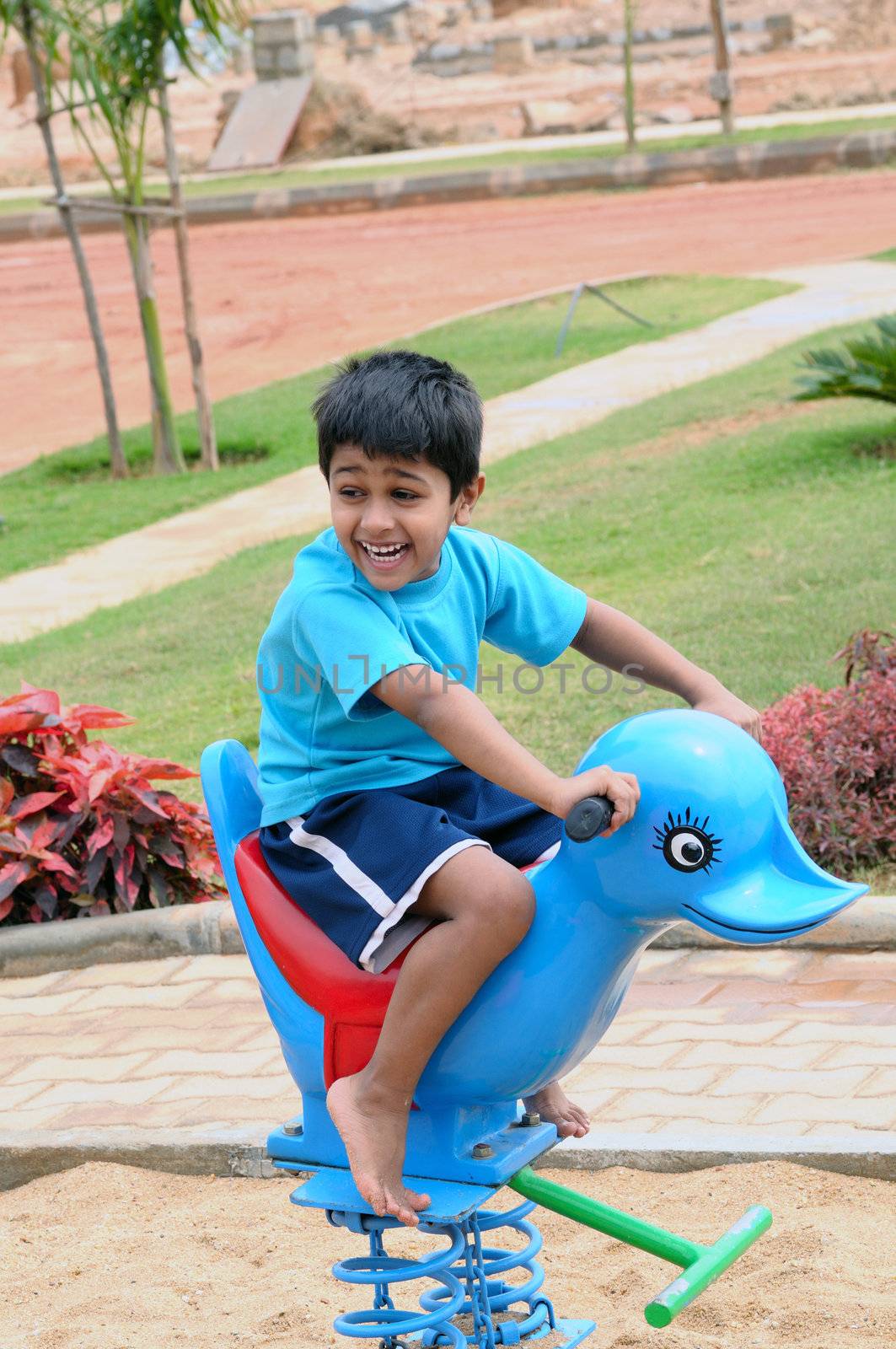 An handsome Indian kid having funat a local park