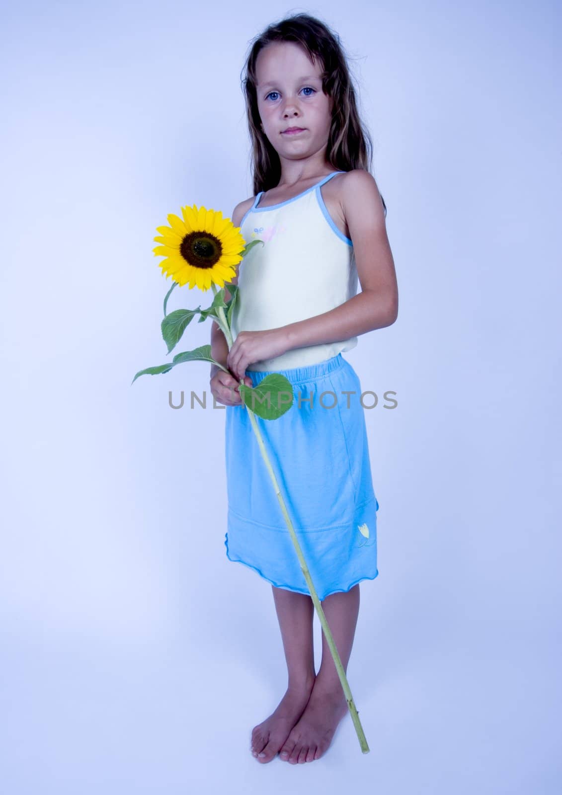 A little girl holding in her hand a beautiful flower