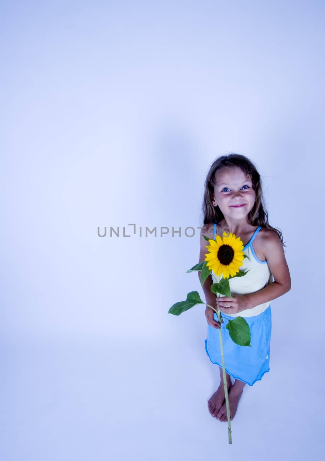 A little girl holding in her hand a beautiful flower