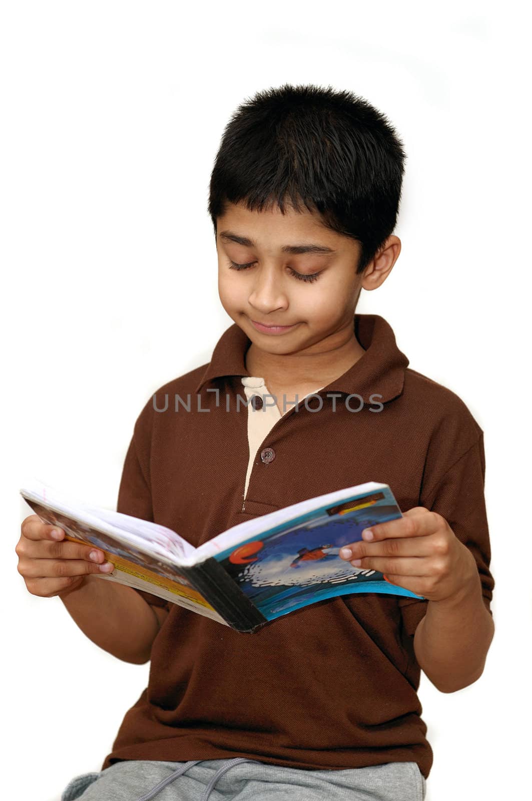 An adorable boy reading his school book