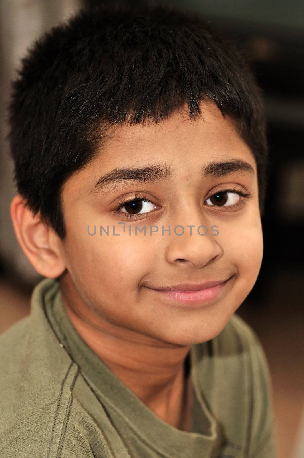 An handsome indian kid smiling for you