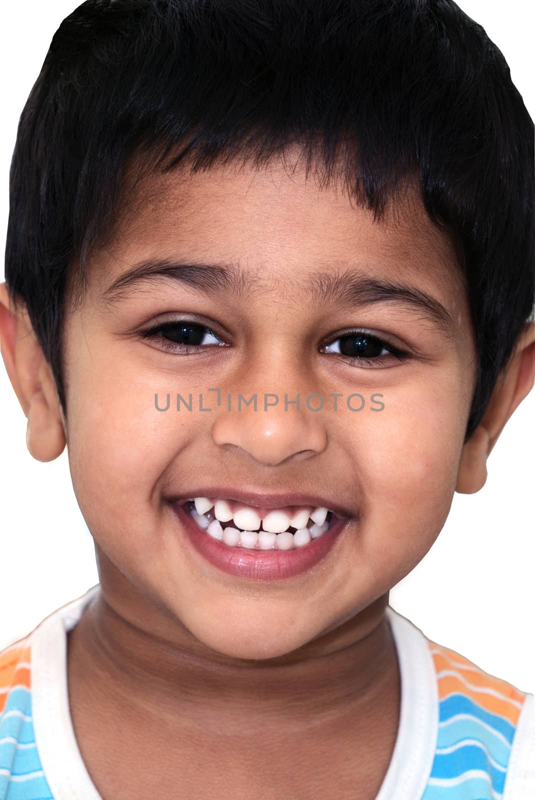 An happy and handsome Indian kid smiling before the camera