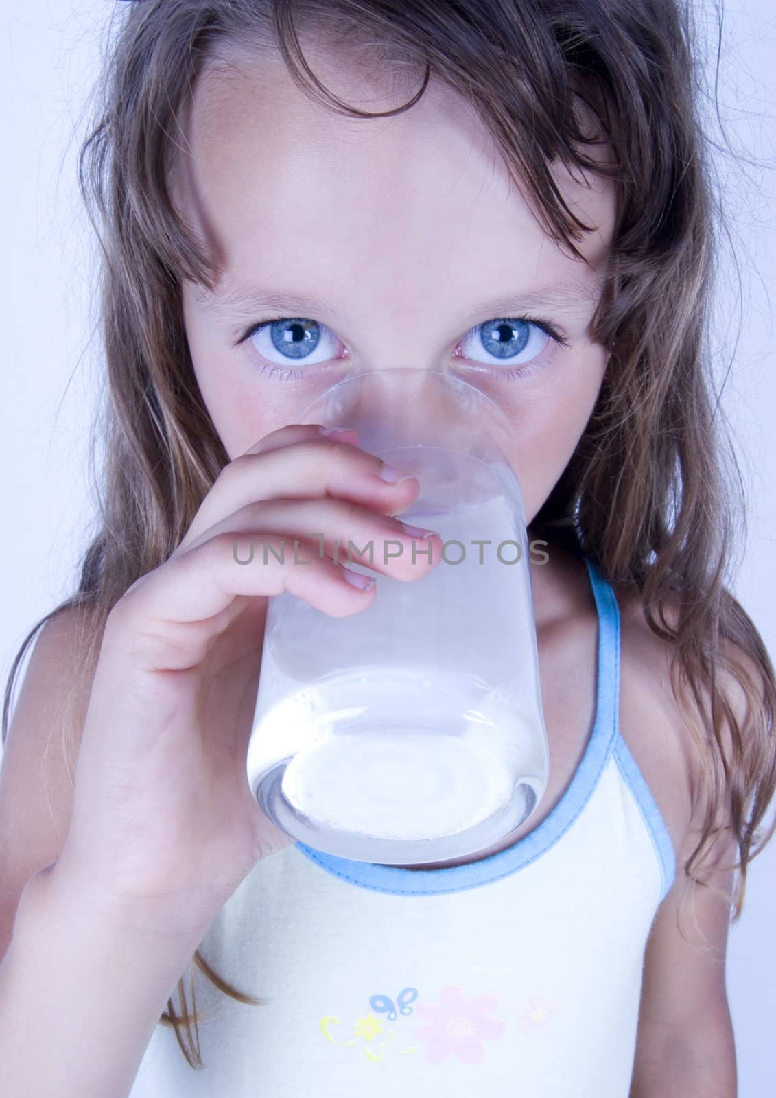 Cute girl with glass of milk