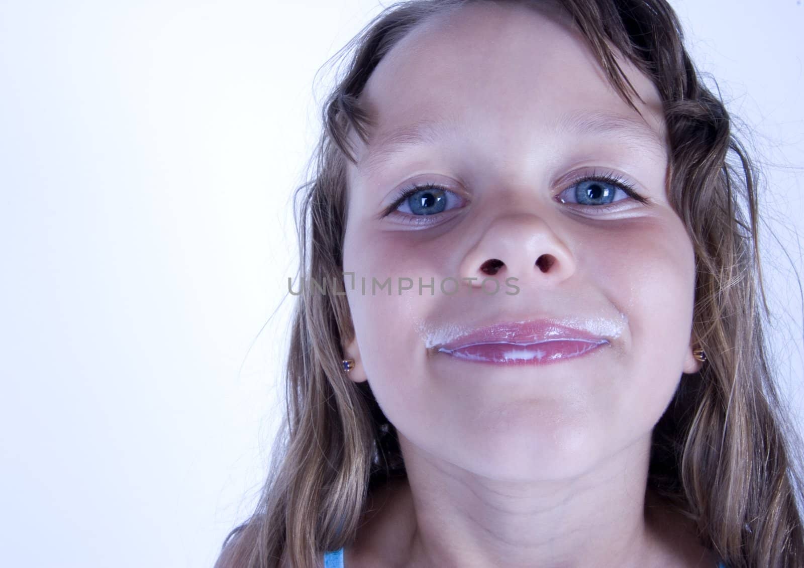 Cute girl with glass of milk