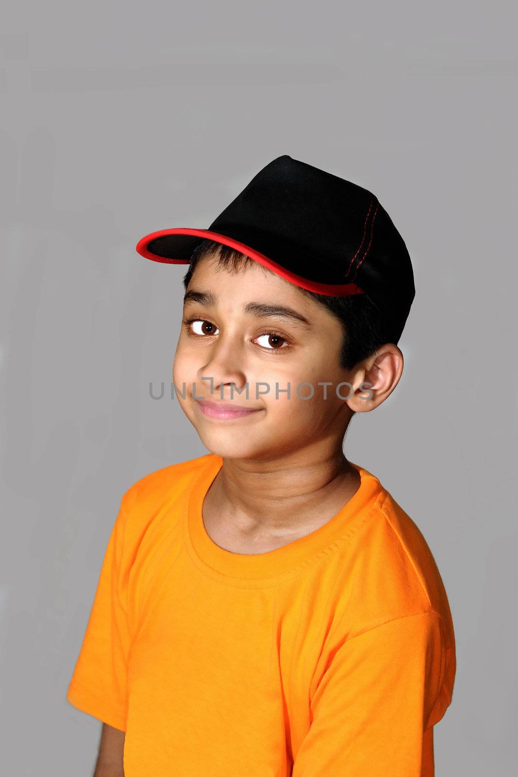 An happy and handsome Indian kid smiling before the camera