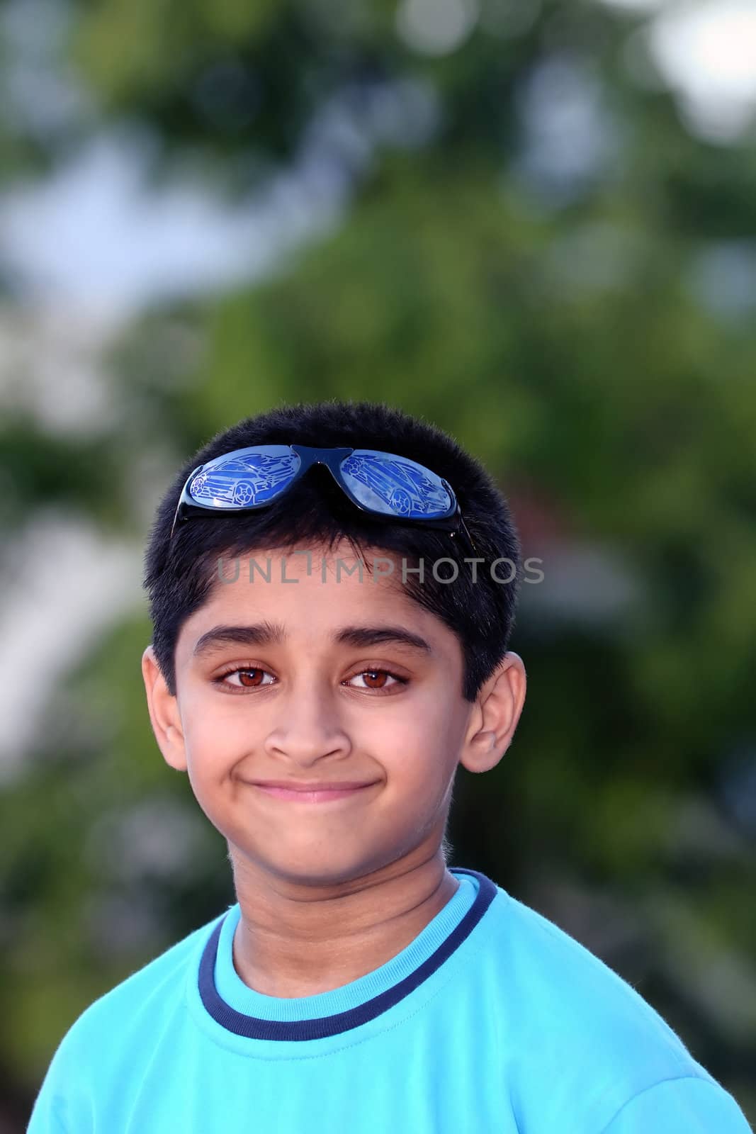An handsome indian kid posing with a smiley face
