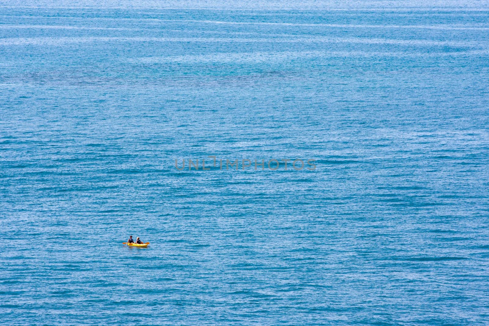 A minimalist photo of a kayak on the open ocean. Photo was taken from the coast of Bermuda.