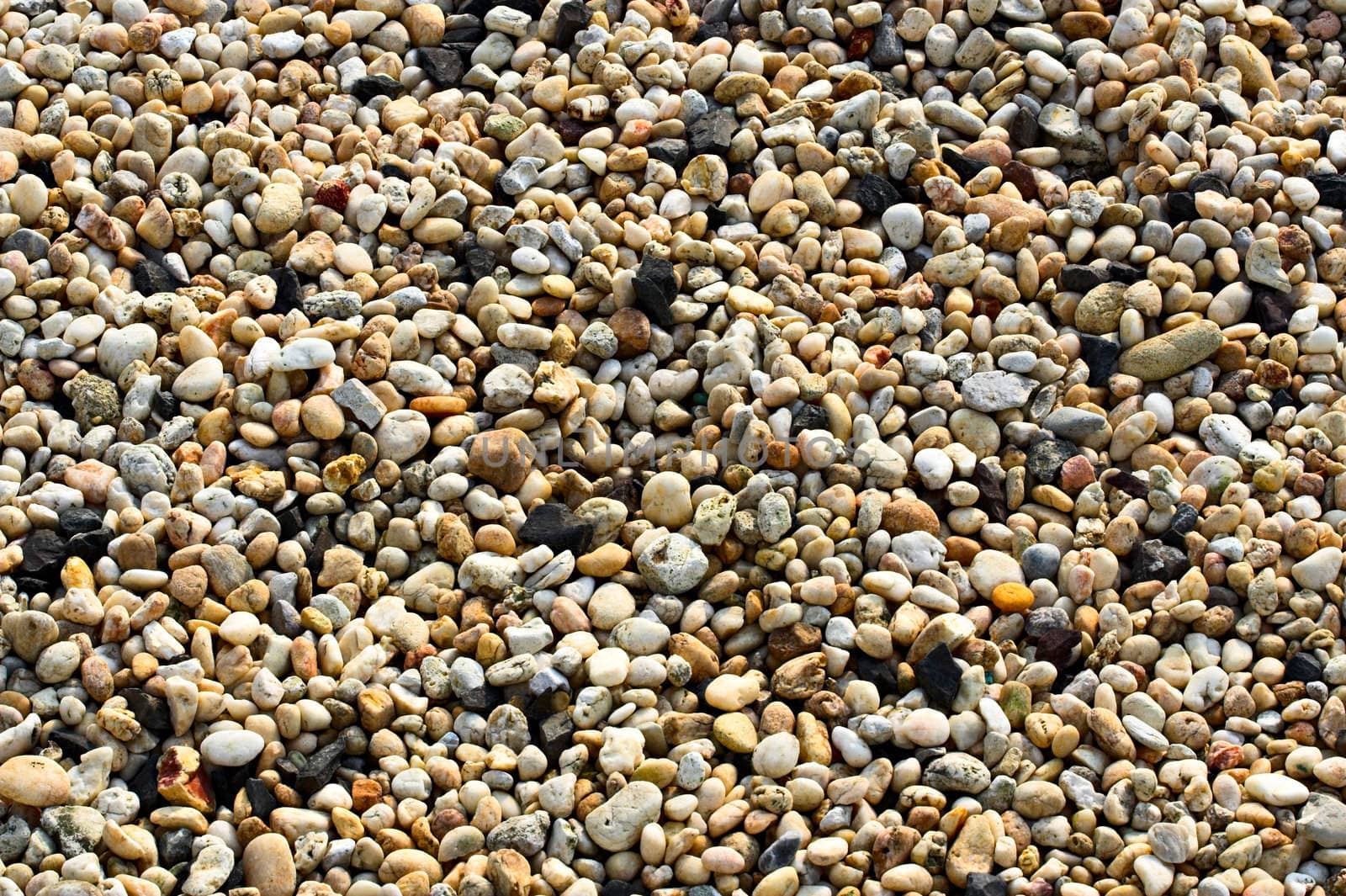 Small pebbles of different colors filling the entire frame