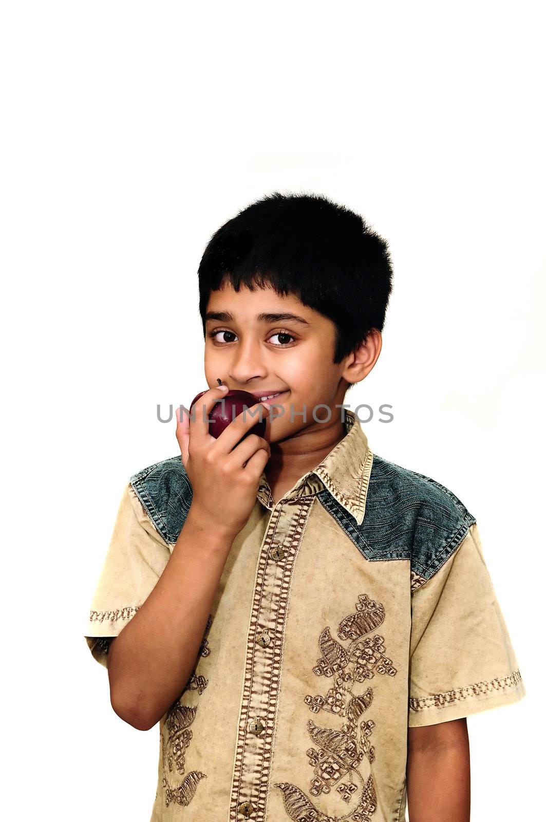 An handsome Indian kid holding apples with a smile