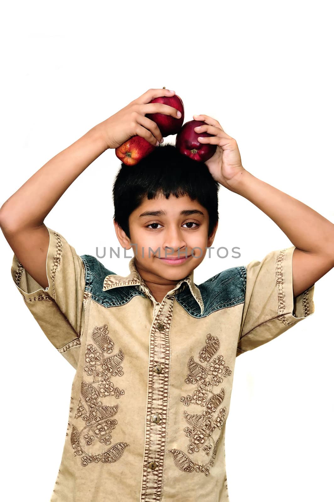 An handsome Indian kid holding apples with a smile