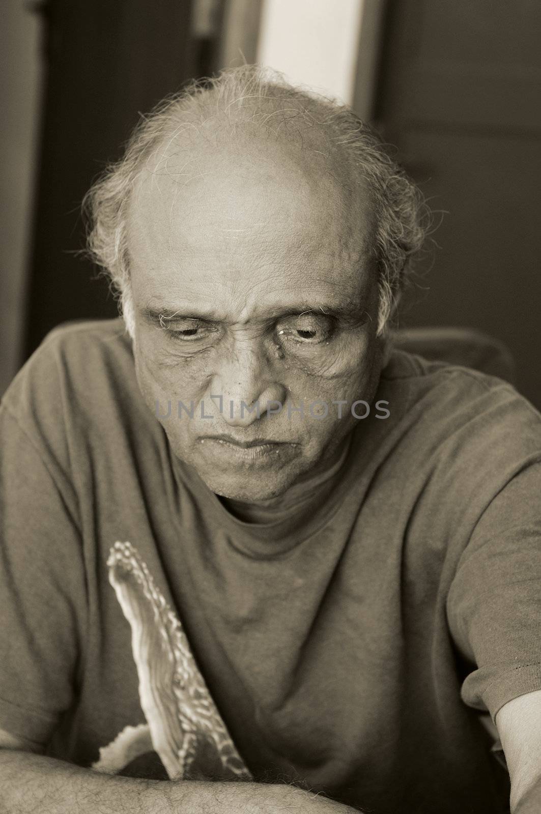 An old man looking very depressed at recession