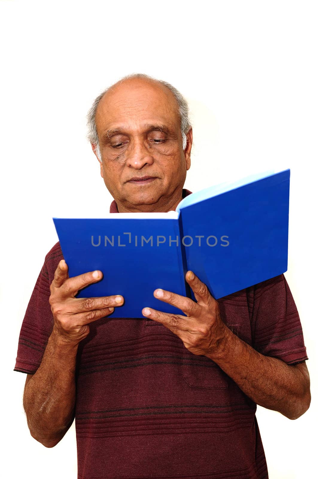 Old Indian Immigrnt reading a blue book