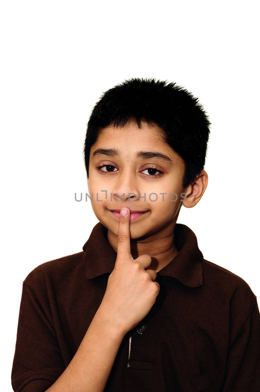 An handsome Indian kid showing sign to be quiet