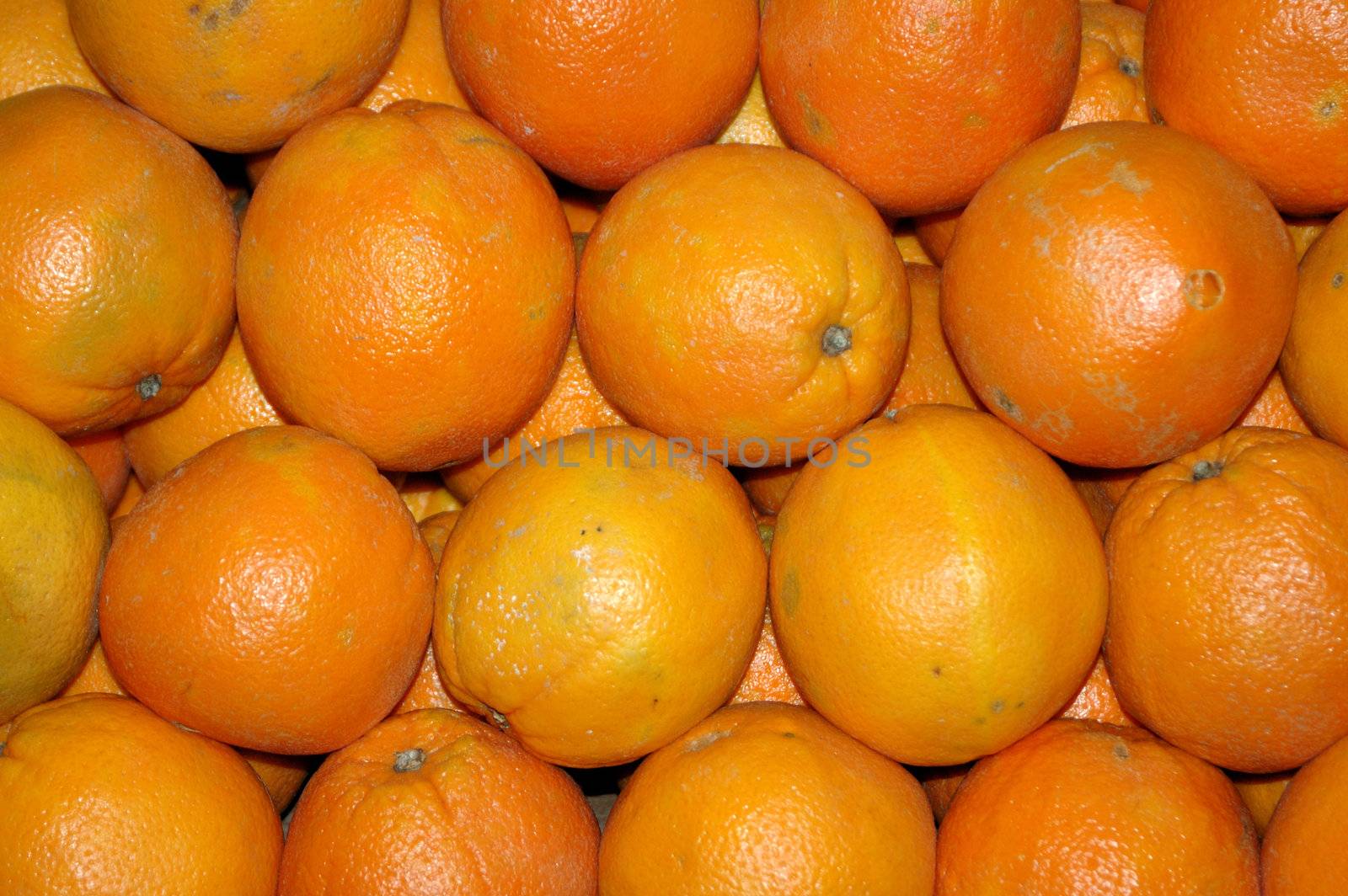 Multiple oranges stacked on top of each other