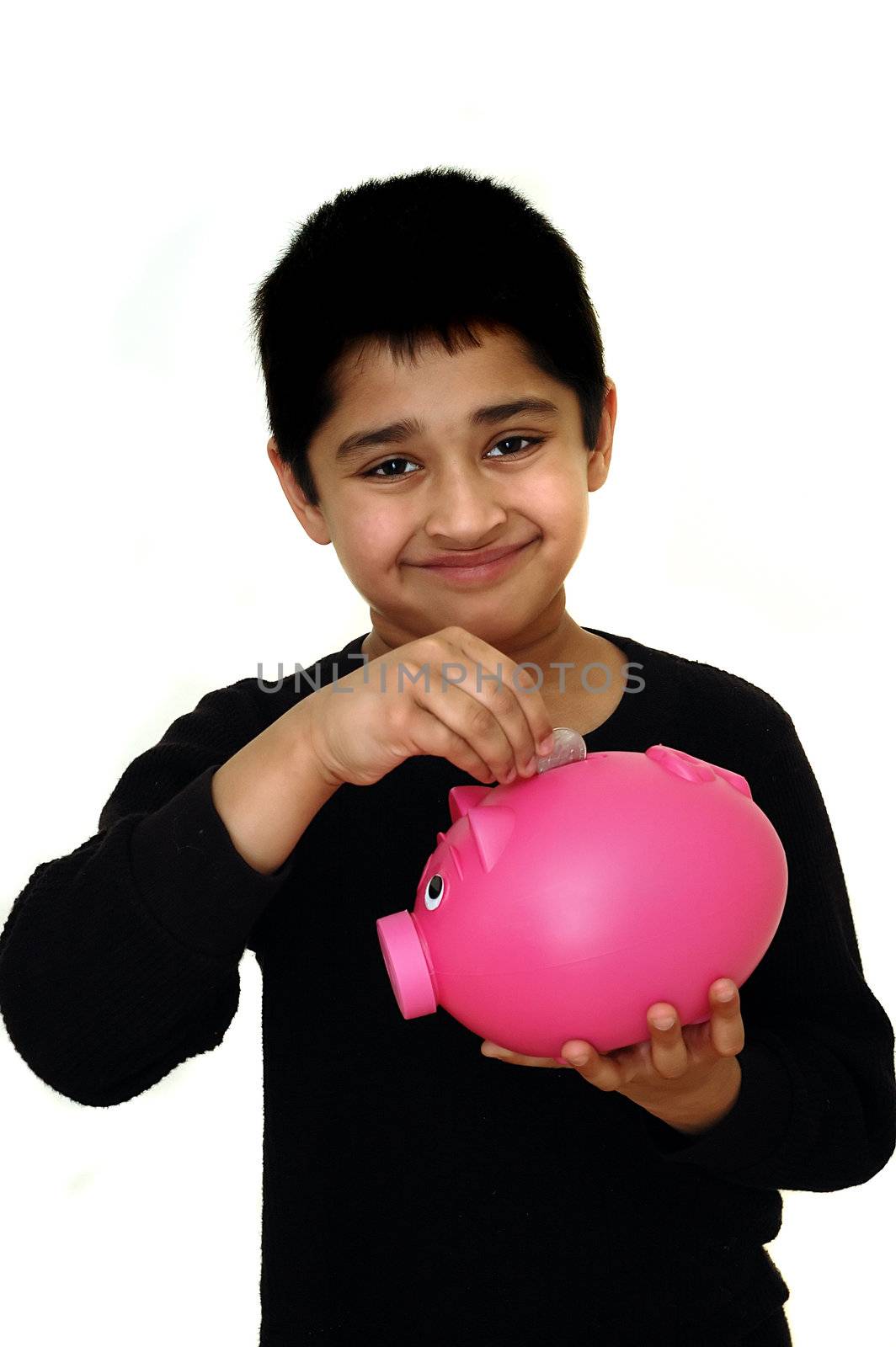 Handsome Indian kid saving money in a piggy bank