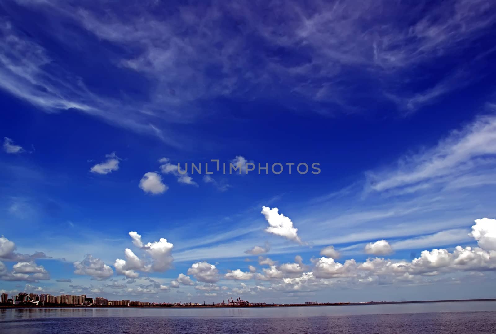 Under the blue sky overlooking the coastal city landscape by xfdly5