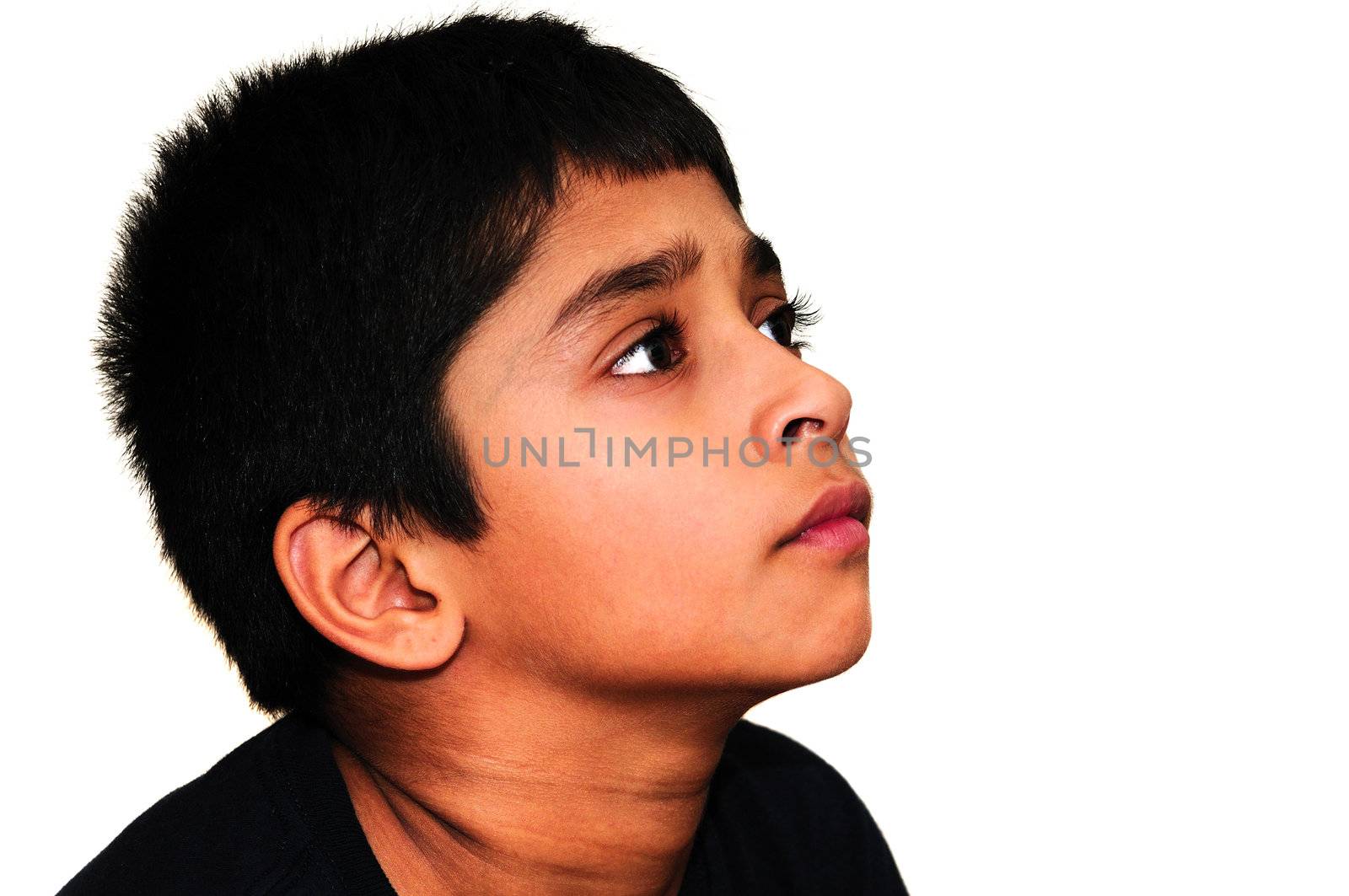 An handsome Indian kid awestruck watching television
