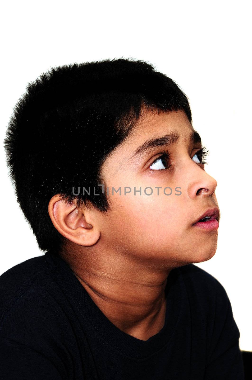 An handsome Indian kid awestruck watching television