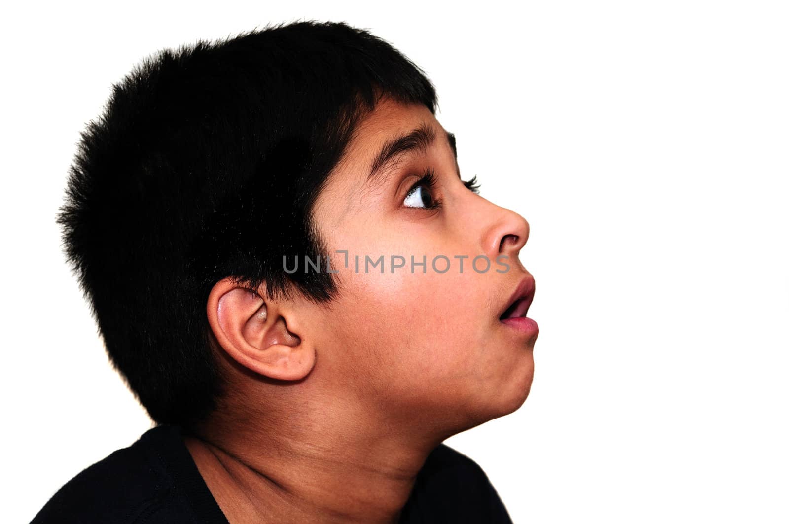 An handsome Indian kid awestruck watching television