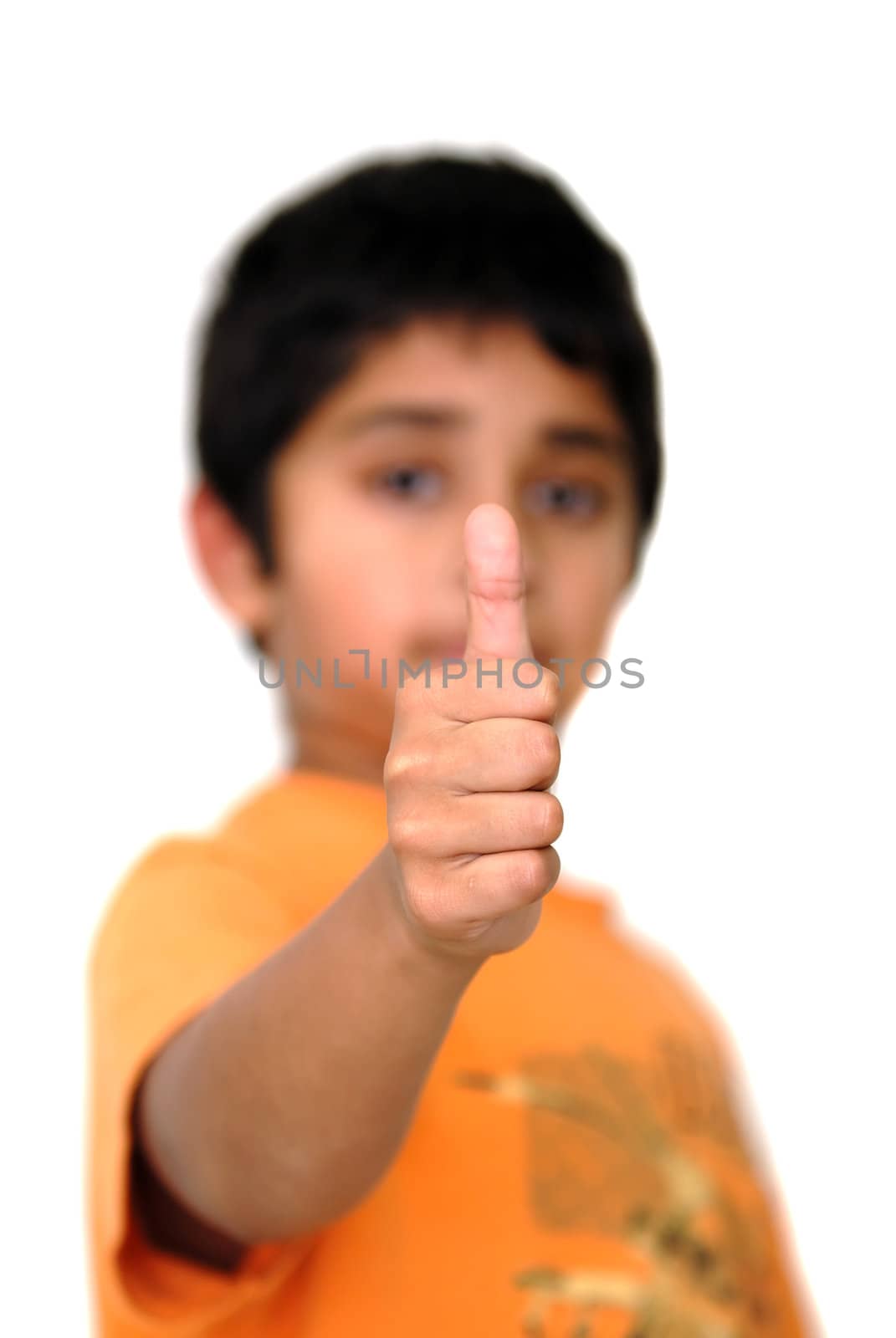 An young boy showing thumbs up indicating success