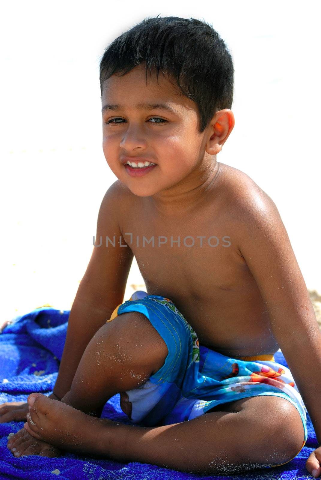 An handsome Indian kid having fun at a tropical beach