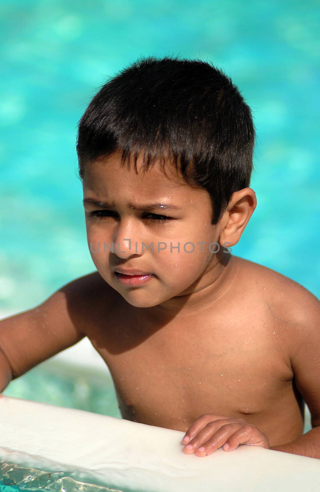 An handsome Indian kid having fun at a tropical beach