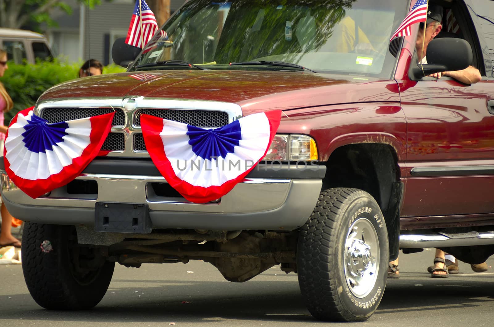 A car patriotically displaying an amerrican flag