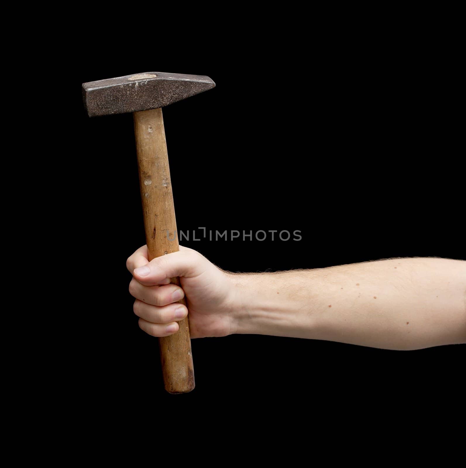 Hammer in a hand isolated on black