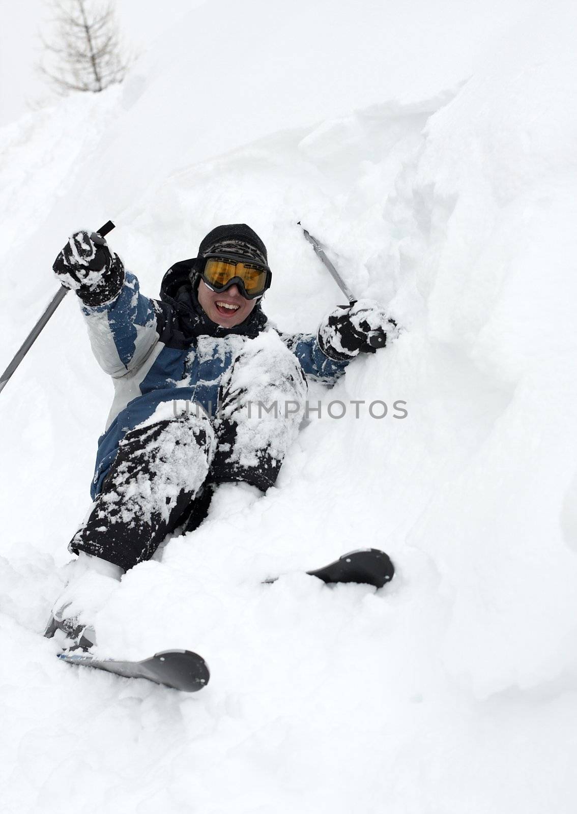 Skier falling over in deep fresh snow