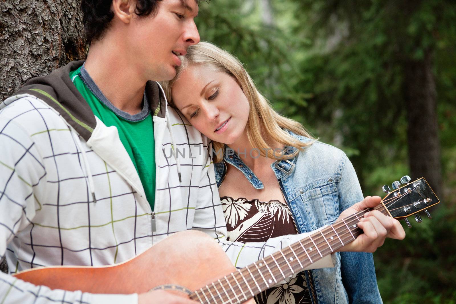 Romantic couple with man playing the guitar