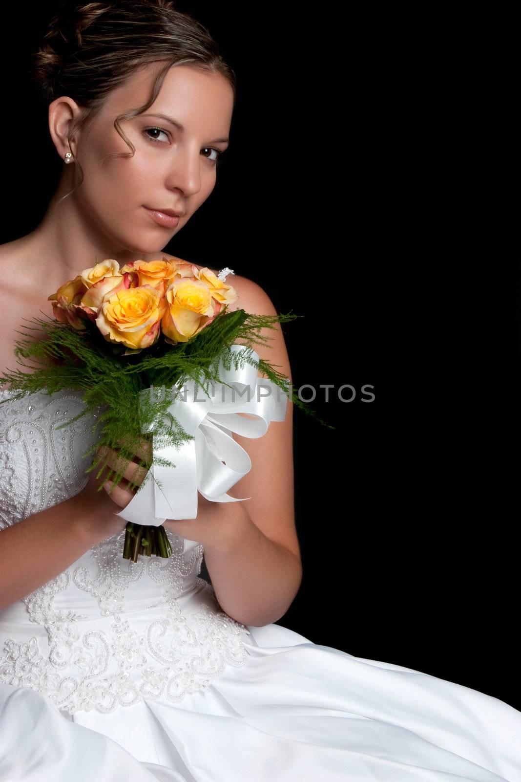 Beautiful young bride holding flowers