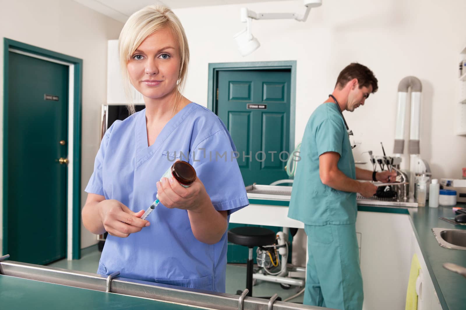Nurse with syringe while doctor writing report by leaf