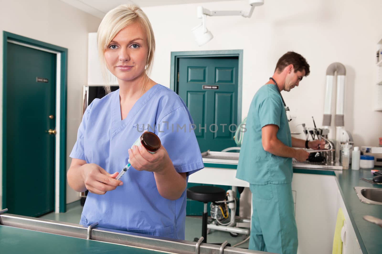 Portrait of vet and assistant in animal clinic getting ready for surgery