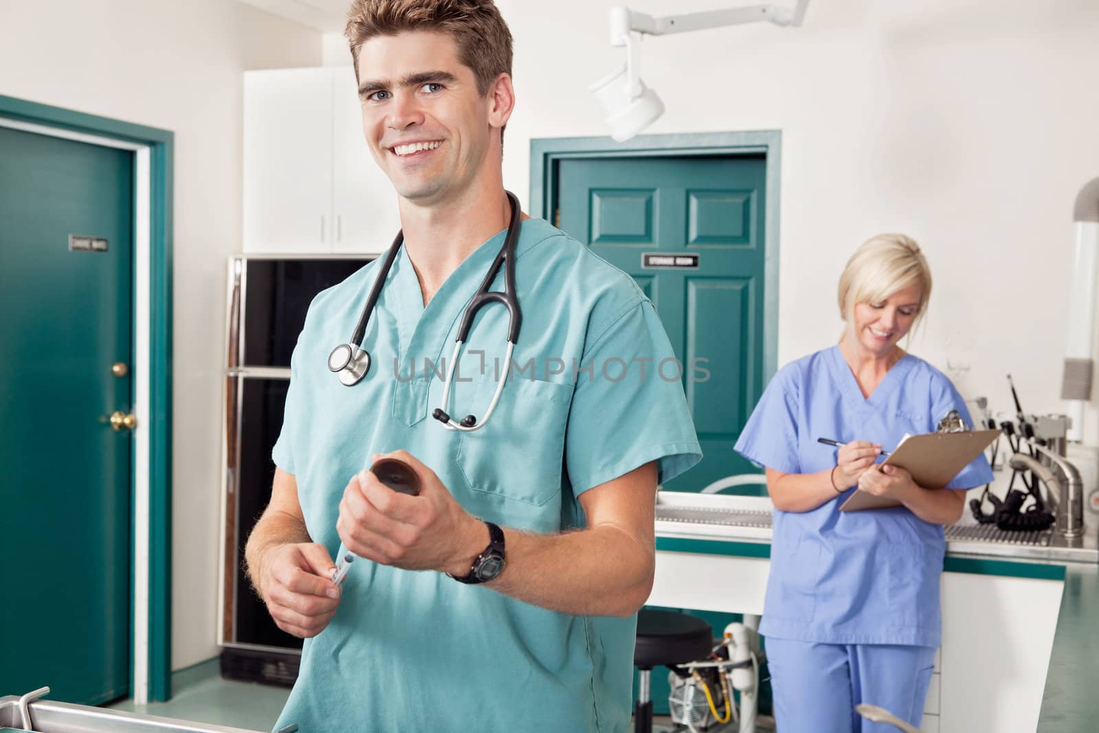 Doctor with syringe while nurse taking down report by leaf