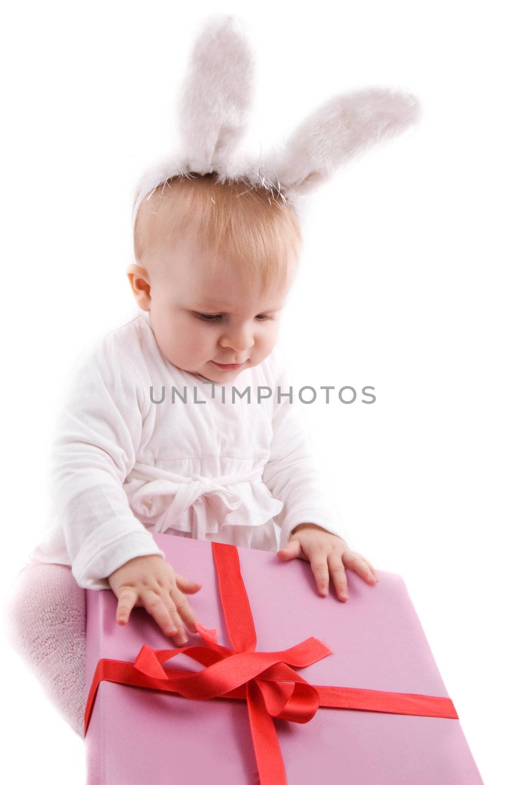 Baby in rabbit costume with pink gift over white